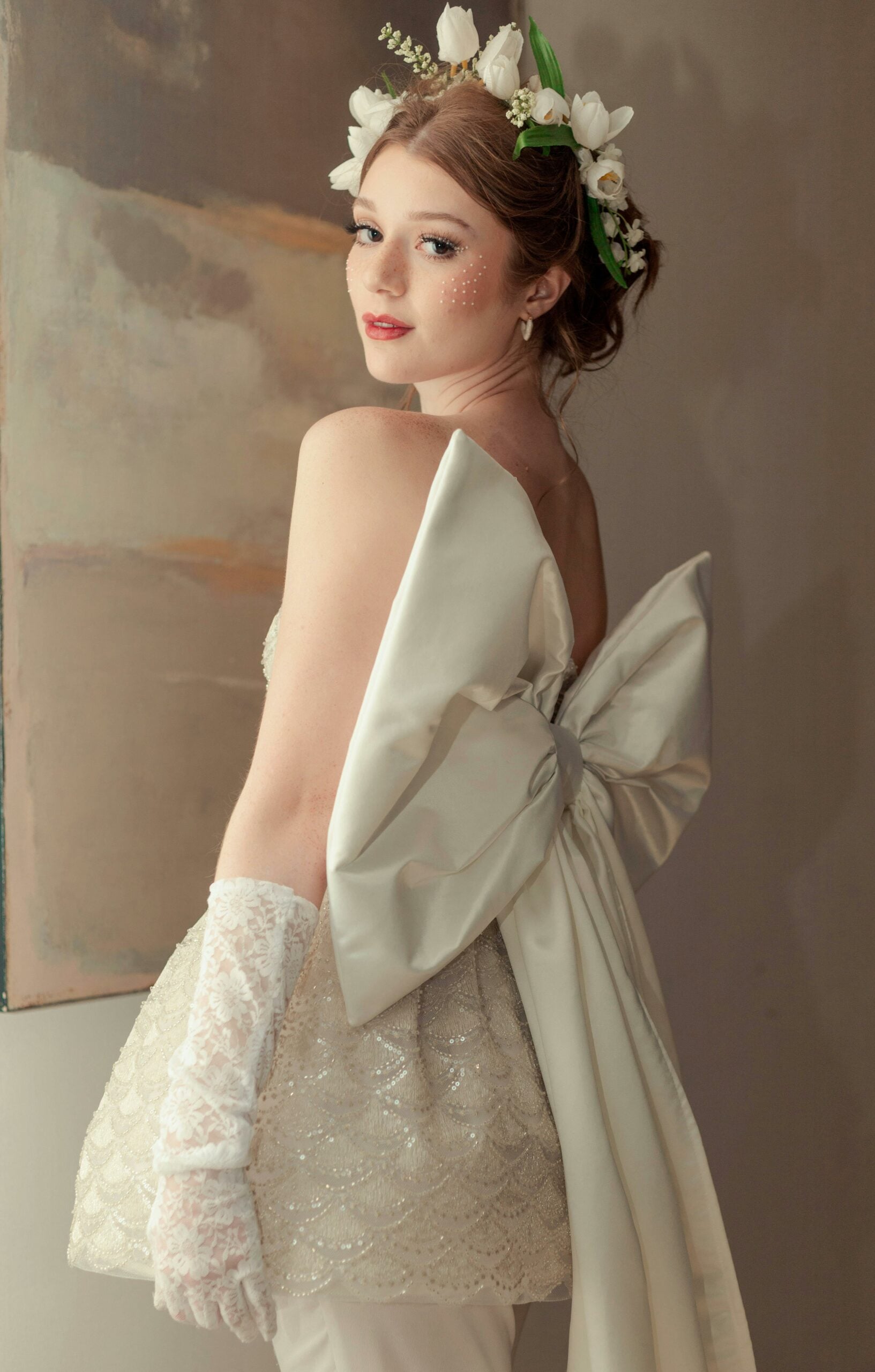 Bride wearing white lace elbow length wedding gloves