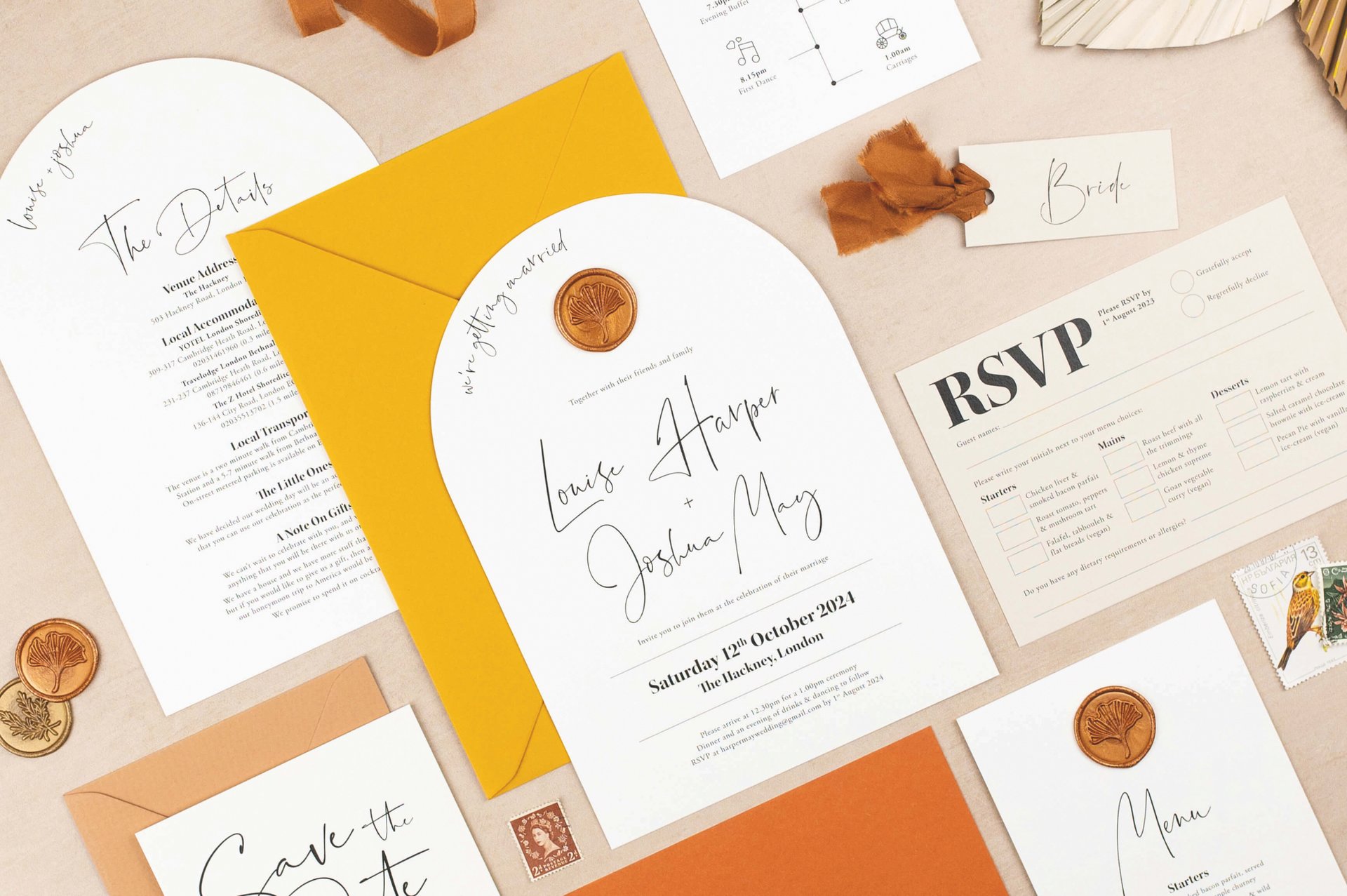 a selection of modern wedding invitations and stationery pieces in a palette of white, rust and yellow.