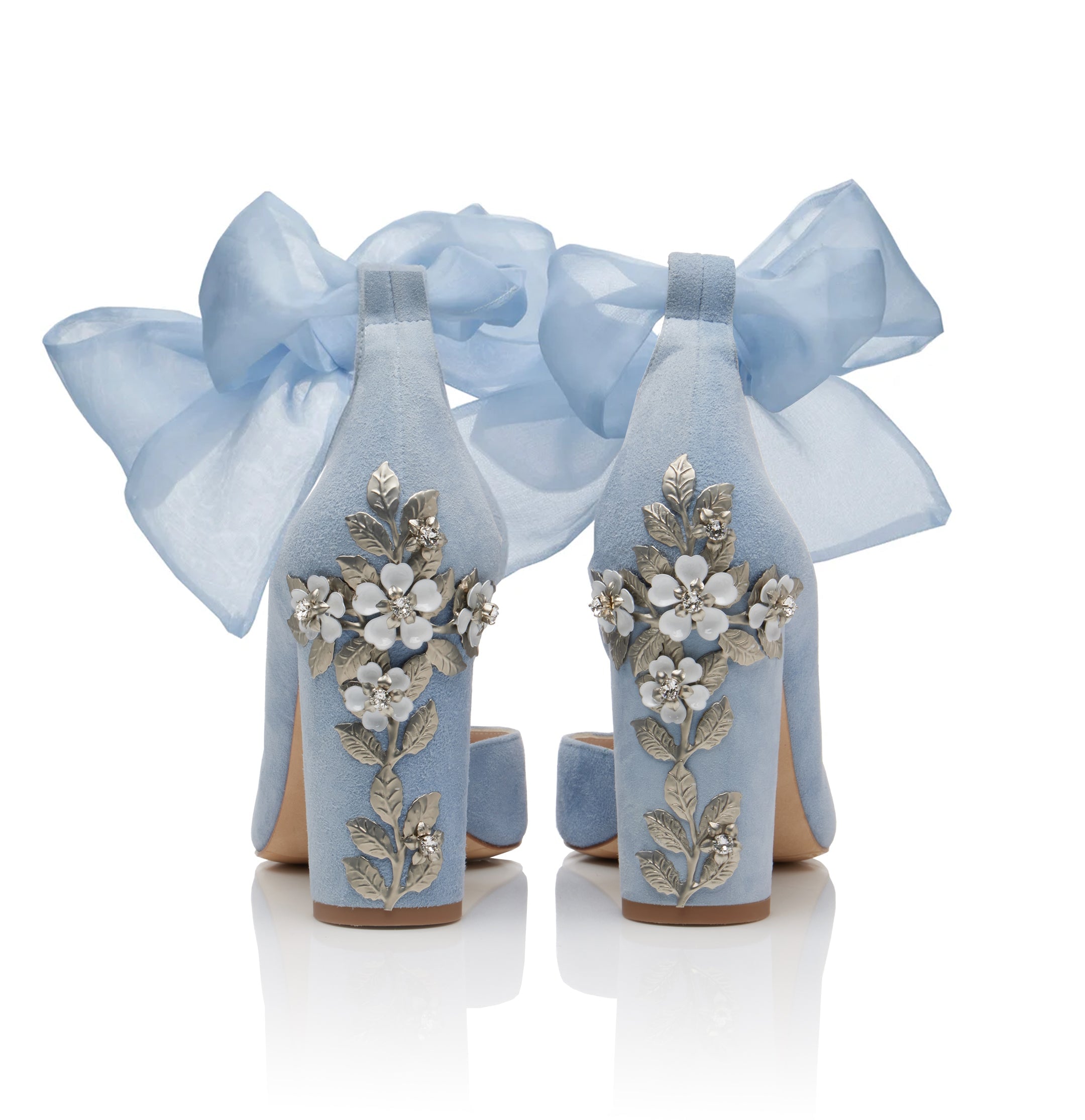 close up of the block heels on a pair of blue wedding shoes which feature organza ankle bows and heavy crystal embellishment