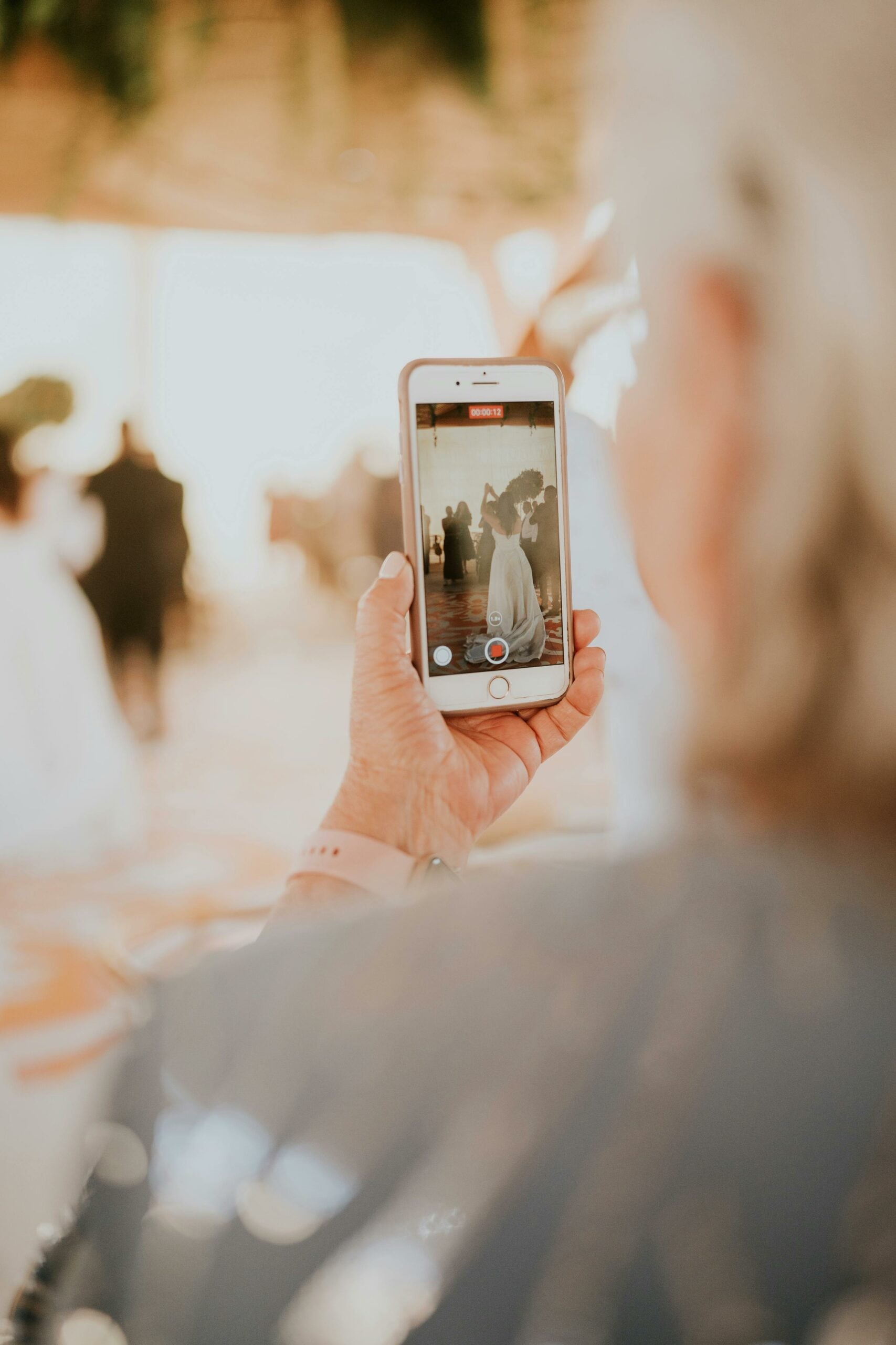 Content creator capturing content on a phone at a wedding