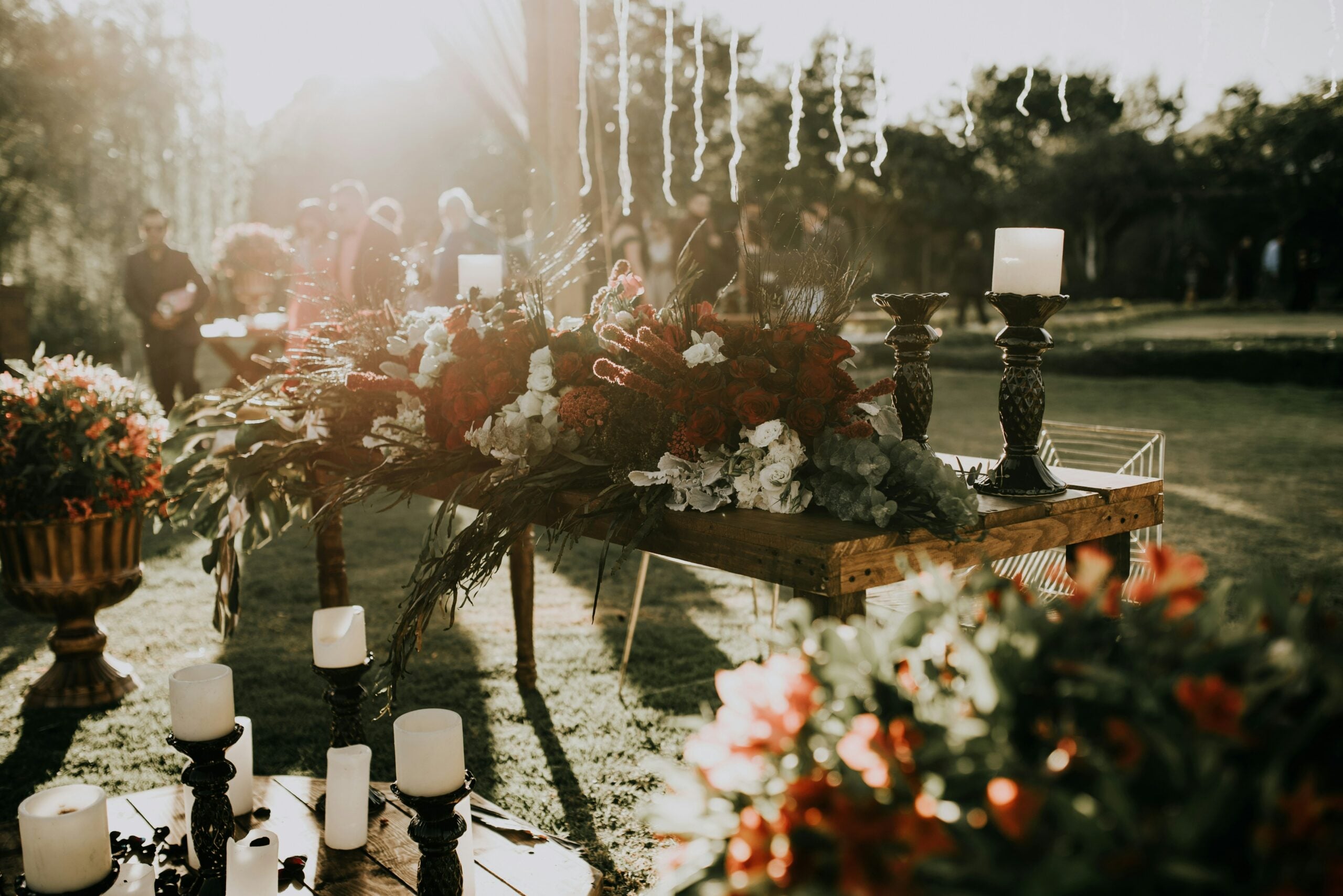 Table at a wedding decorated with florals and pillar candles