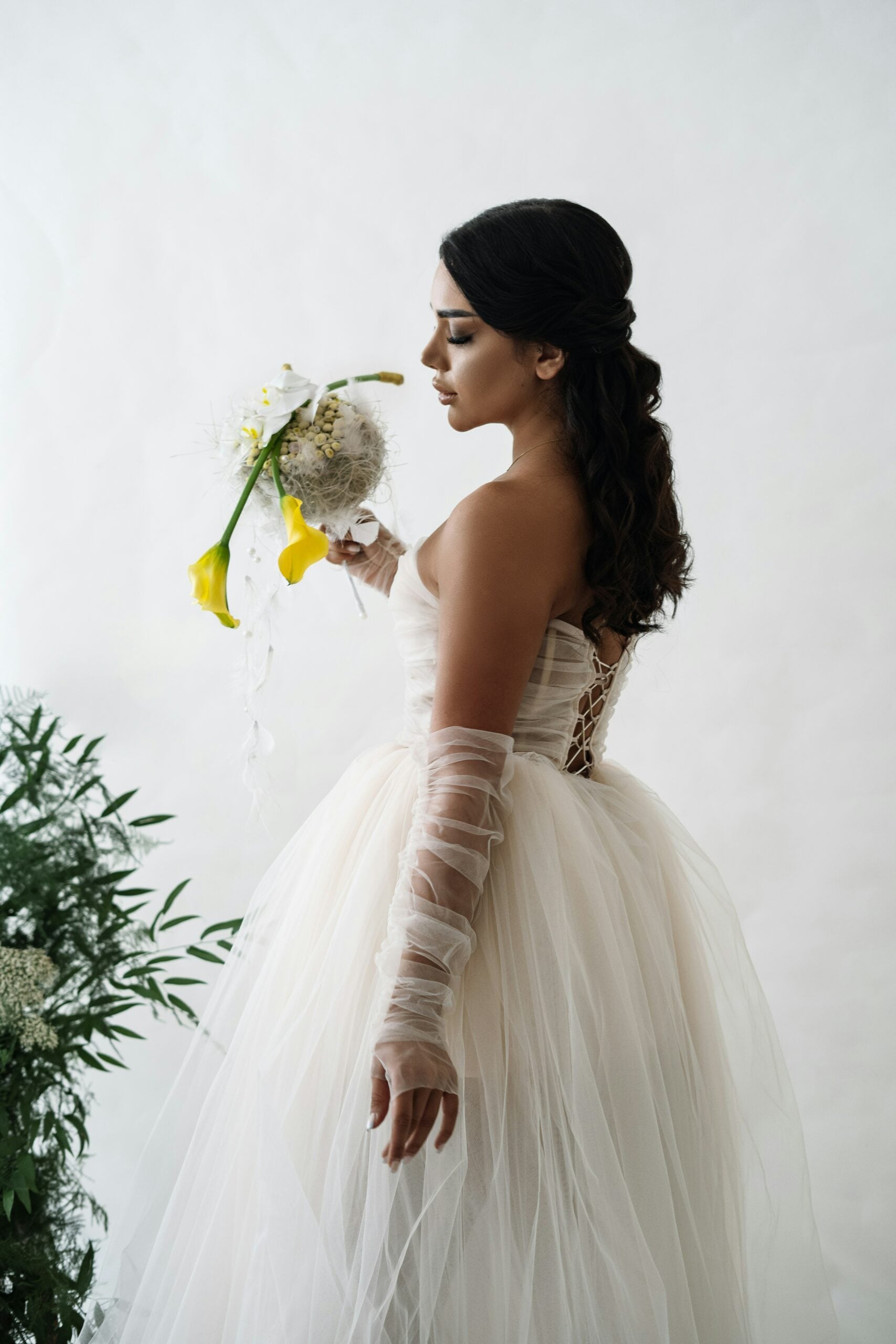 Bride wearing fingerless tulle wedding gloves