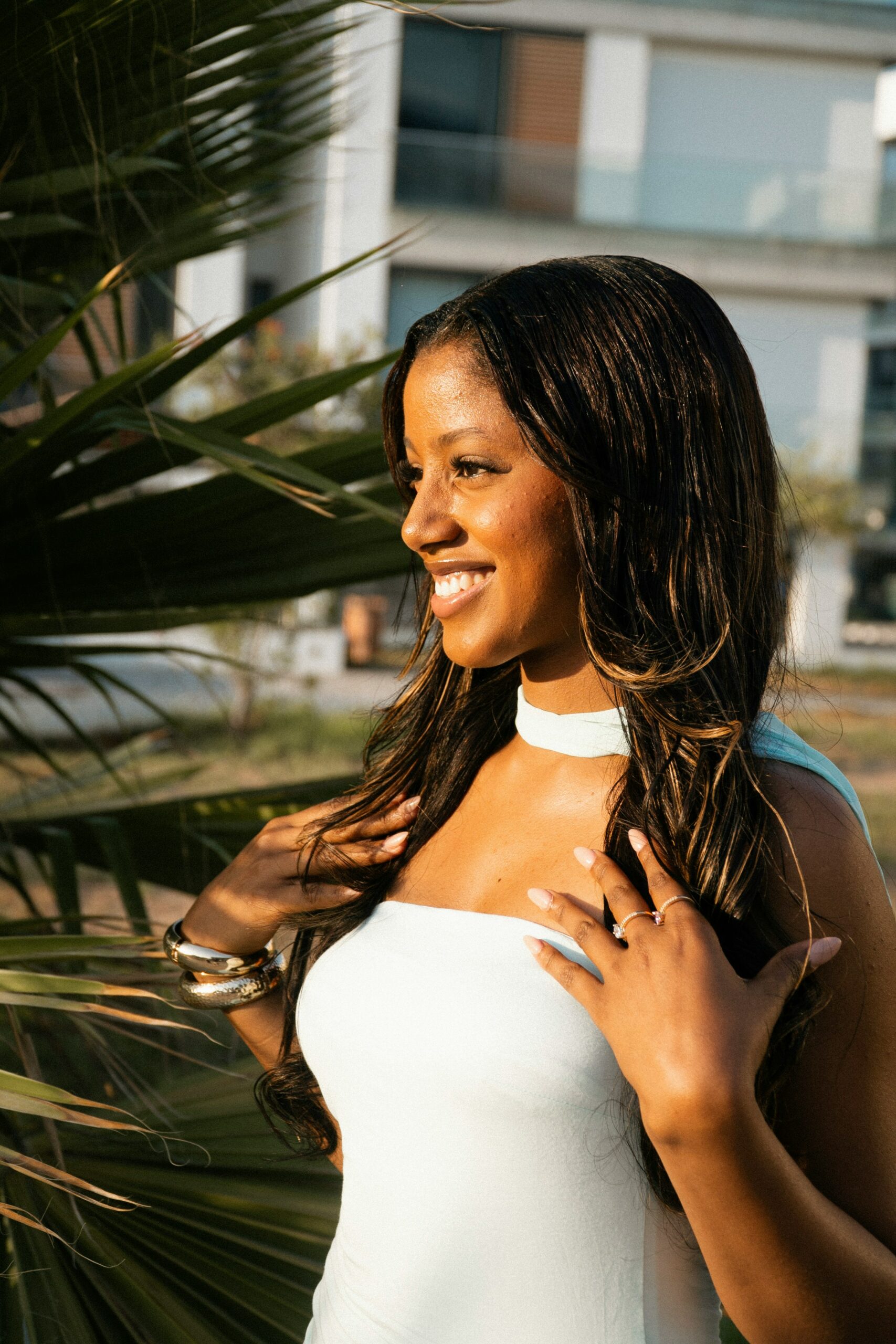 Bride with a simple choker smiling in the sun