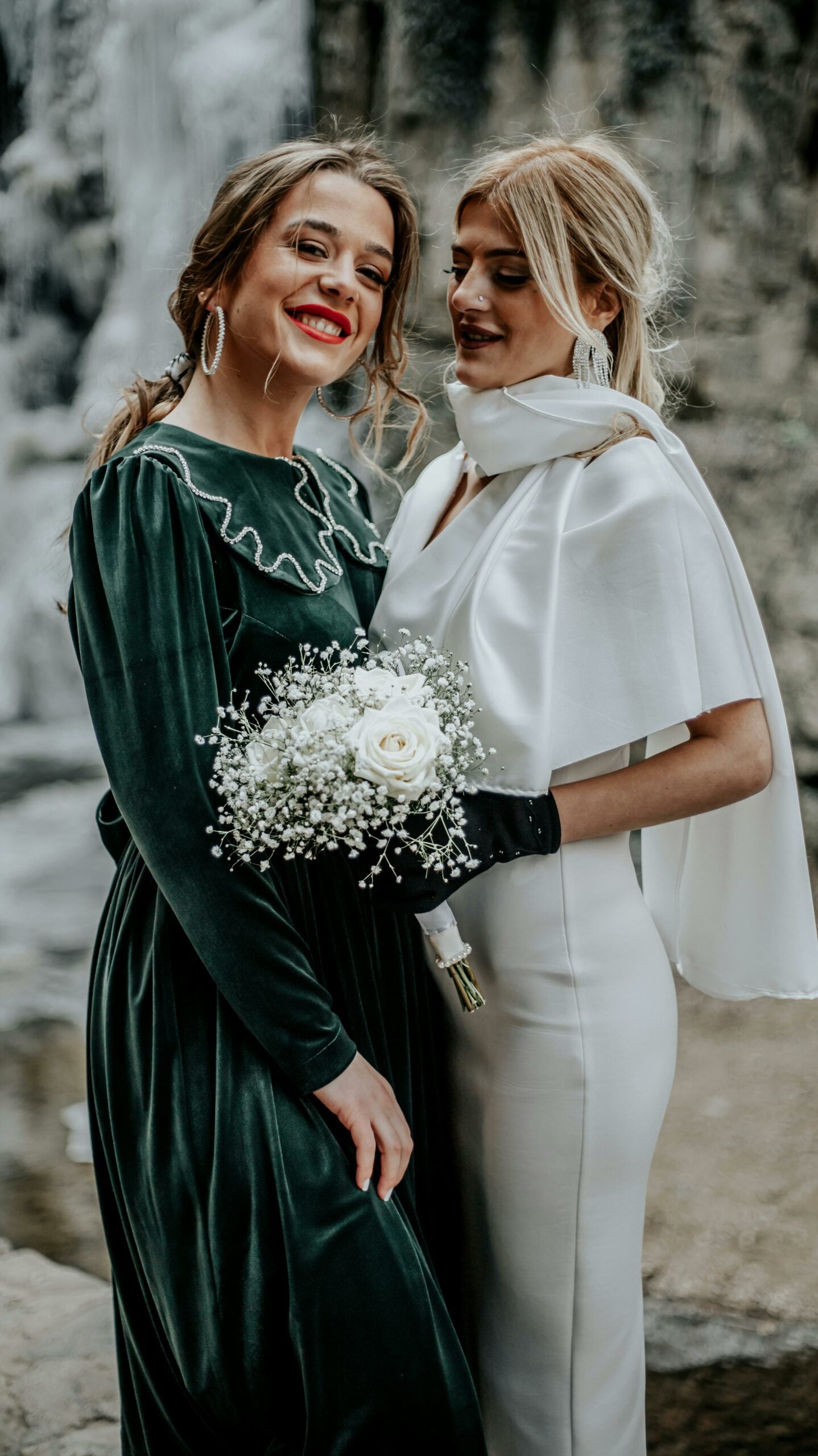 bride with a bridesmaid in a green dress