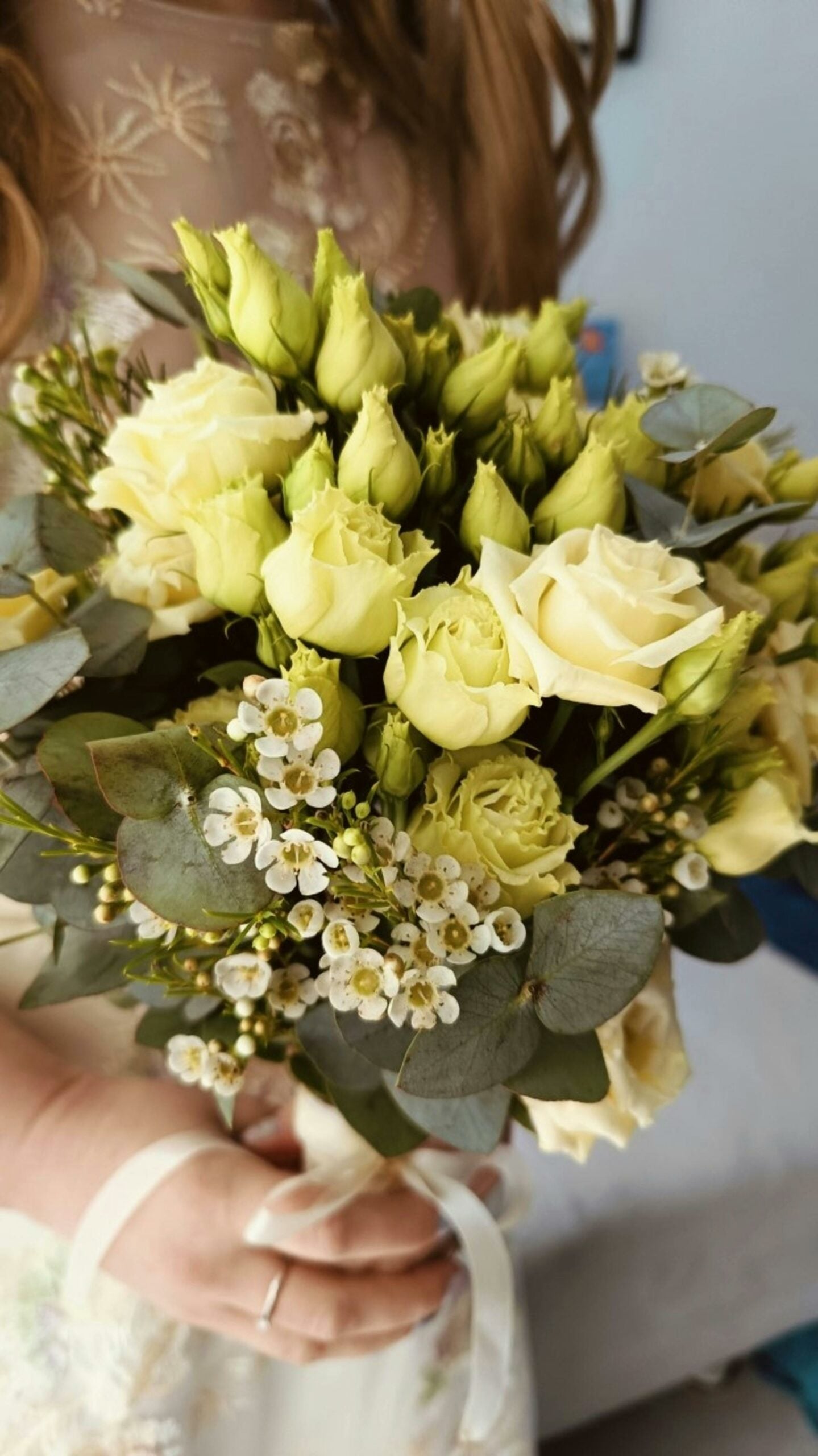 A close up image of a wedding bouquet with white roses