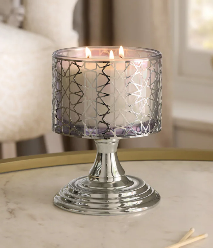 candle in a silver star holder