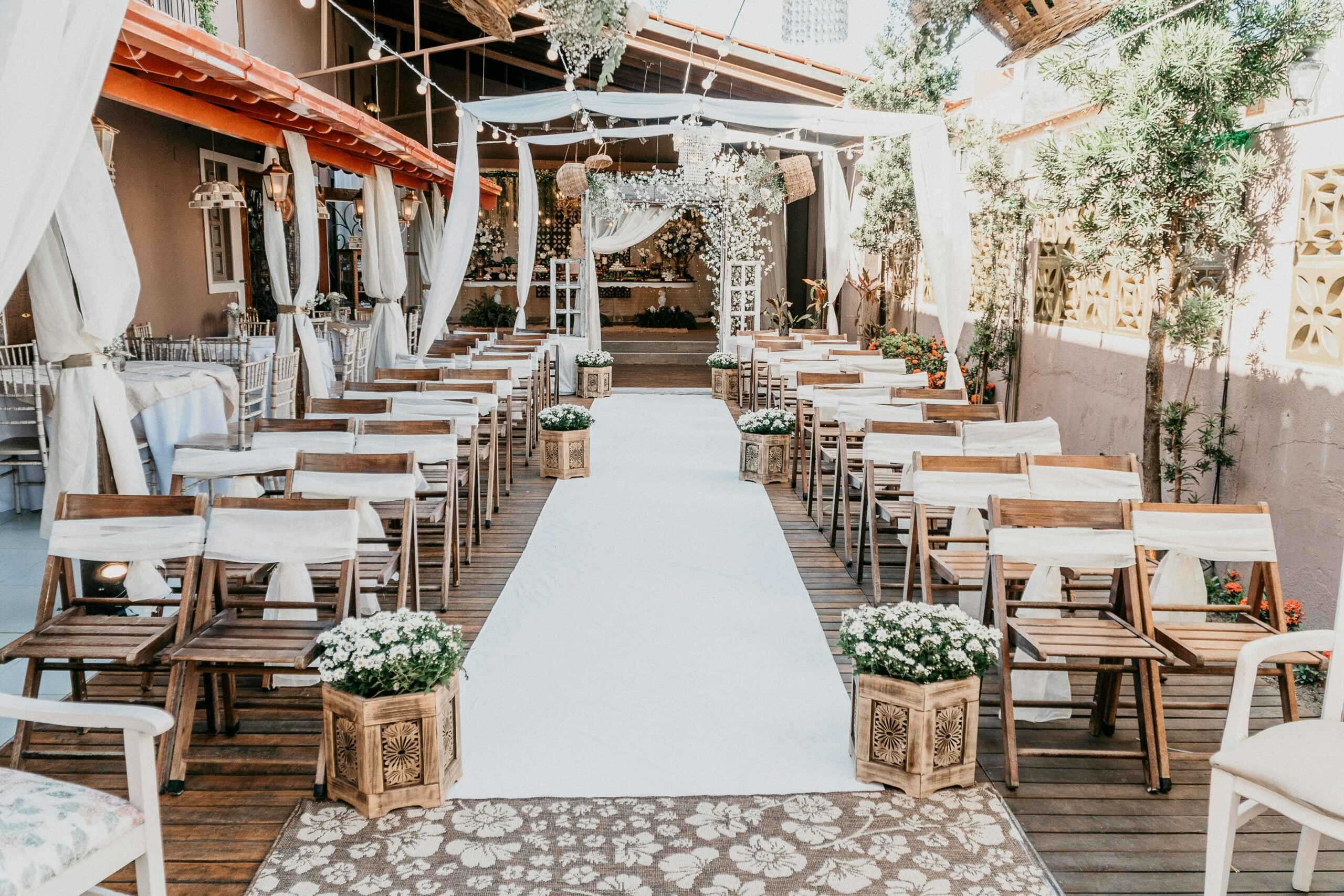 A wedding ceremony aisle with seats set up either side of it