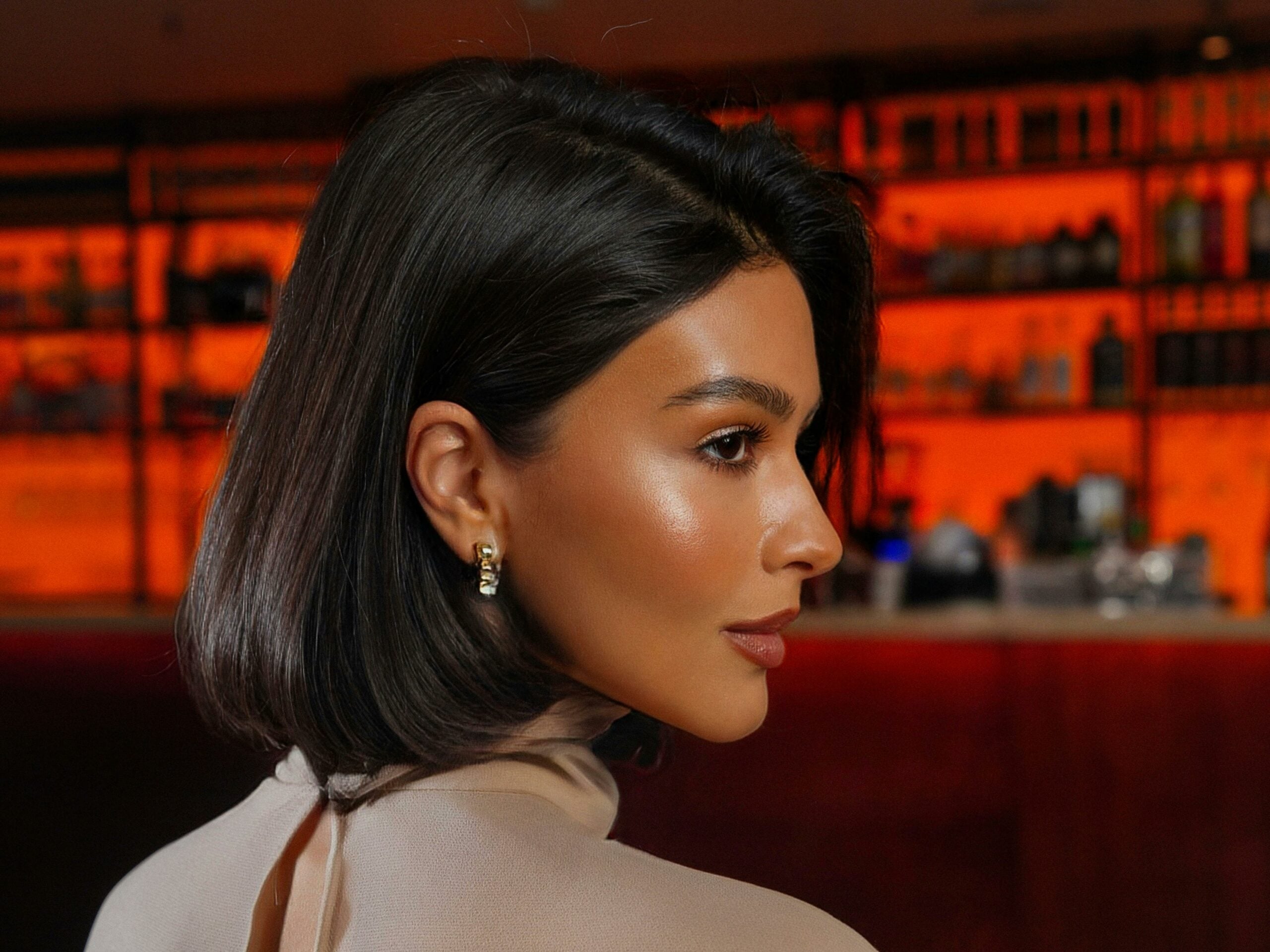 Woman with curled bob at a bar