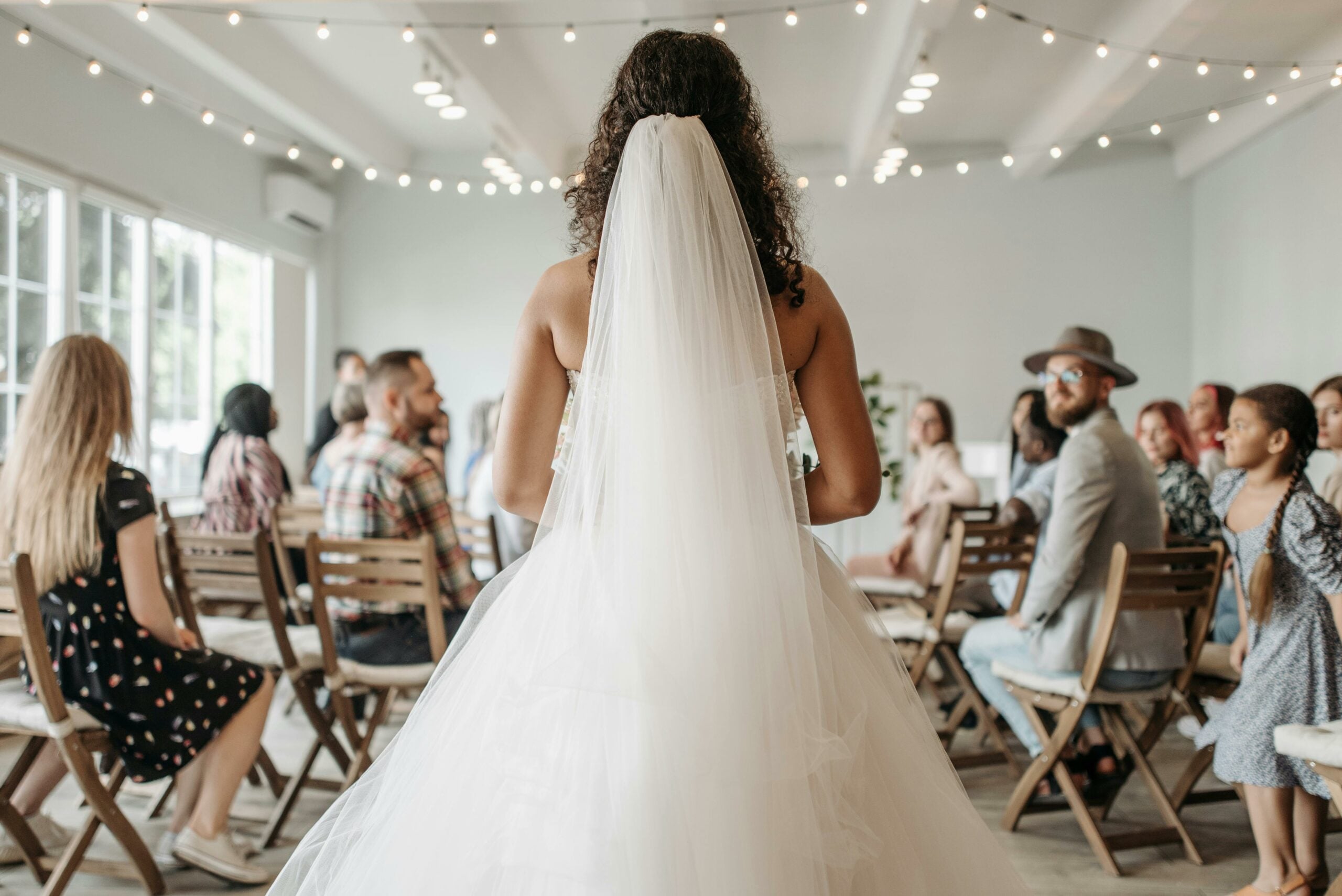 Rear view of a bride wearing a veil as she's about to walk down the aisle