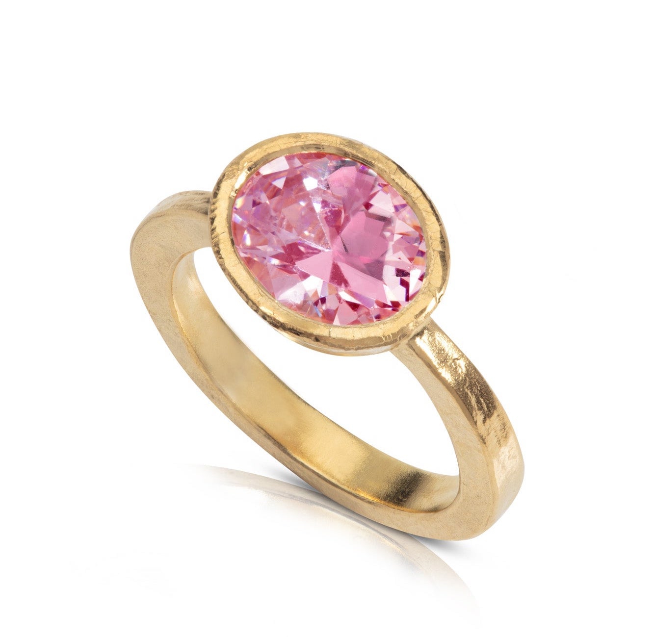 a hammered yellow gold engagement ring with pink gemstone in bezel setting