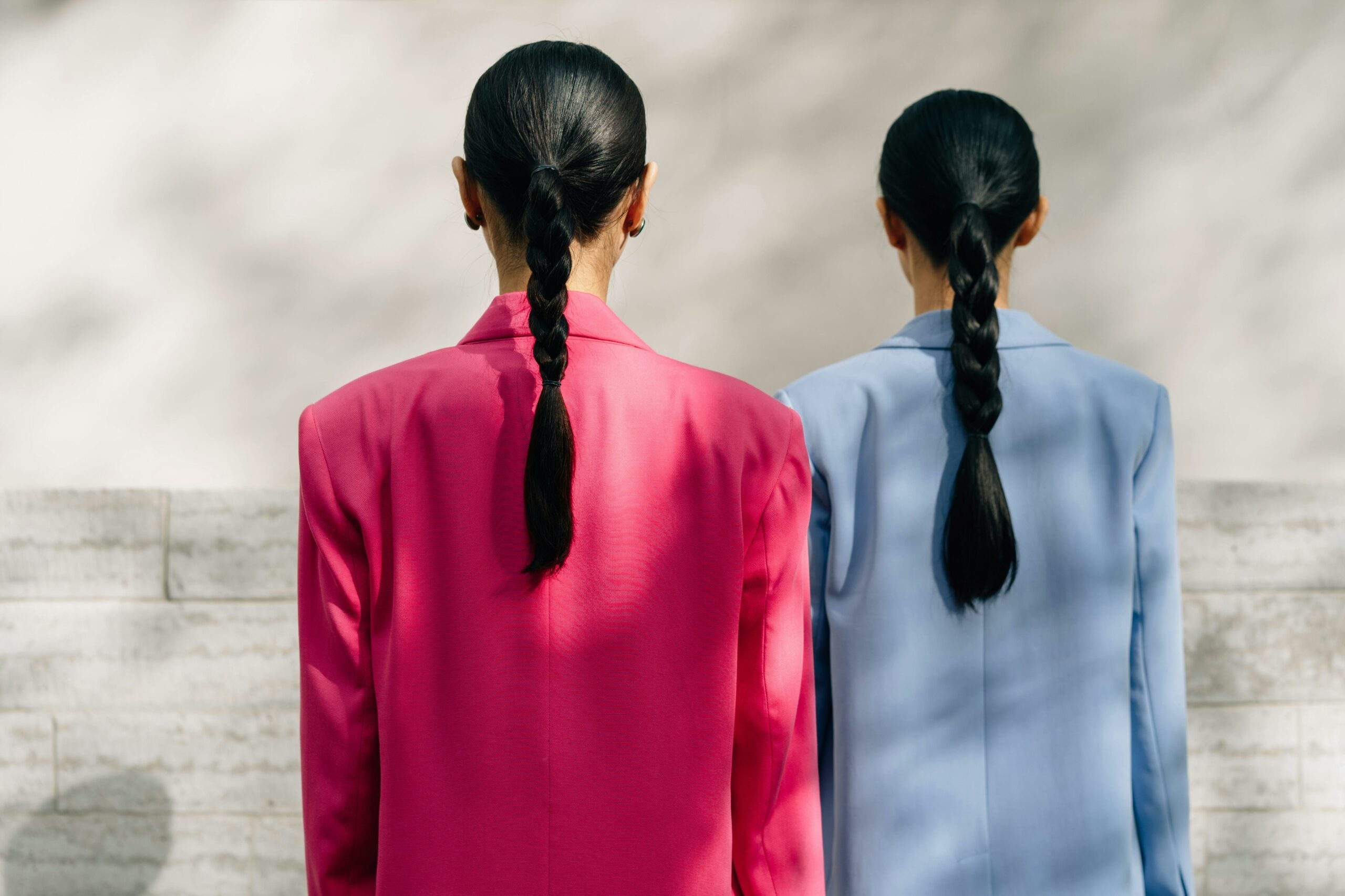 two individuals with low rponytails