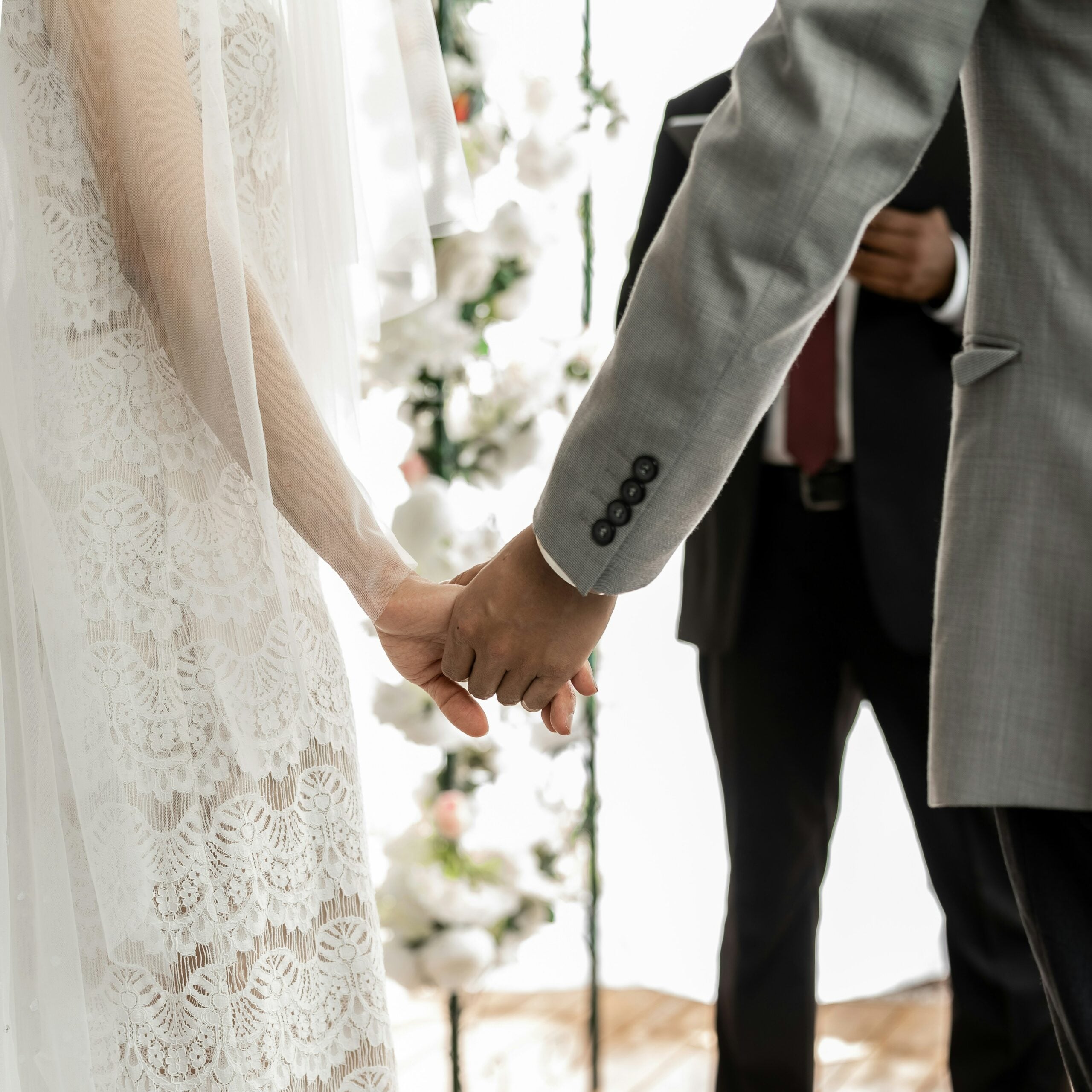 bride and groom holding hands during their wedding ceremony