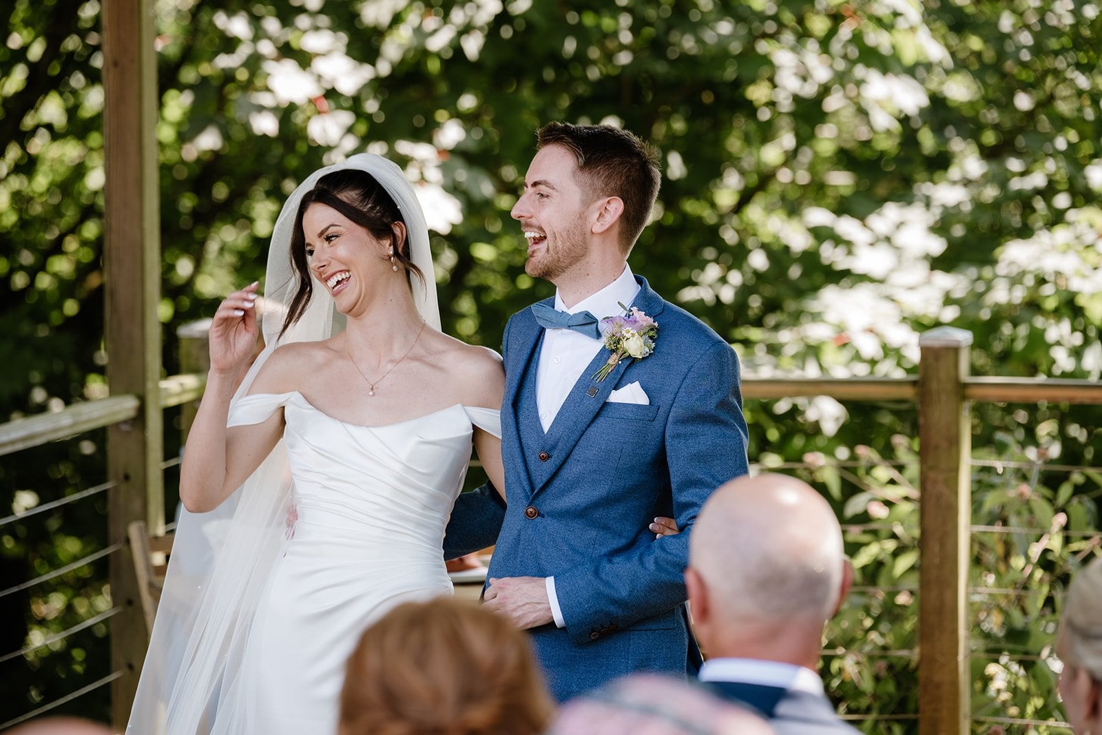 a bride and groom laughing during their wedding ceremony