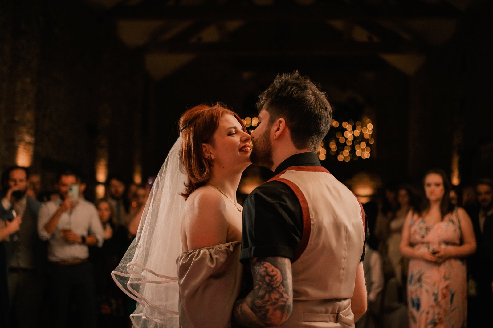 a bride and groom look into each other's eyes and smile as they dance their first dance