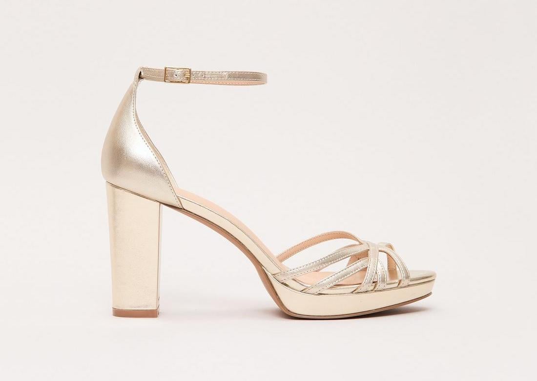 a gold leather strappy sandal with platform heel