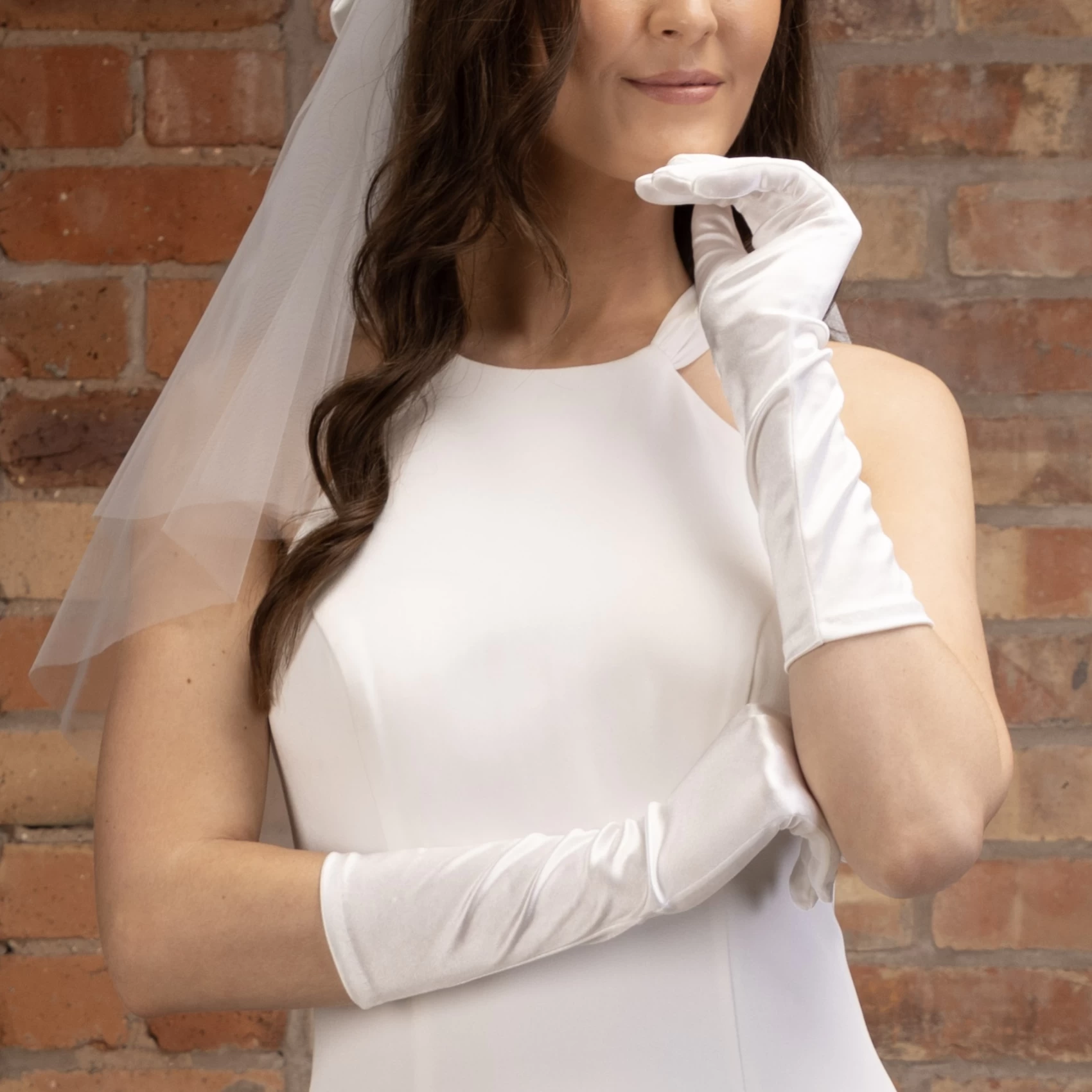 Bride wearing short satin gloves