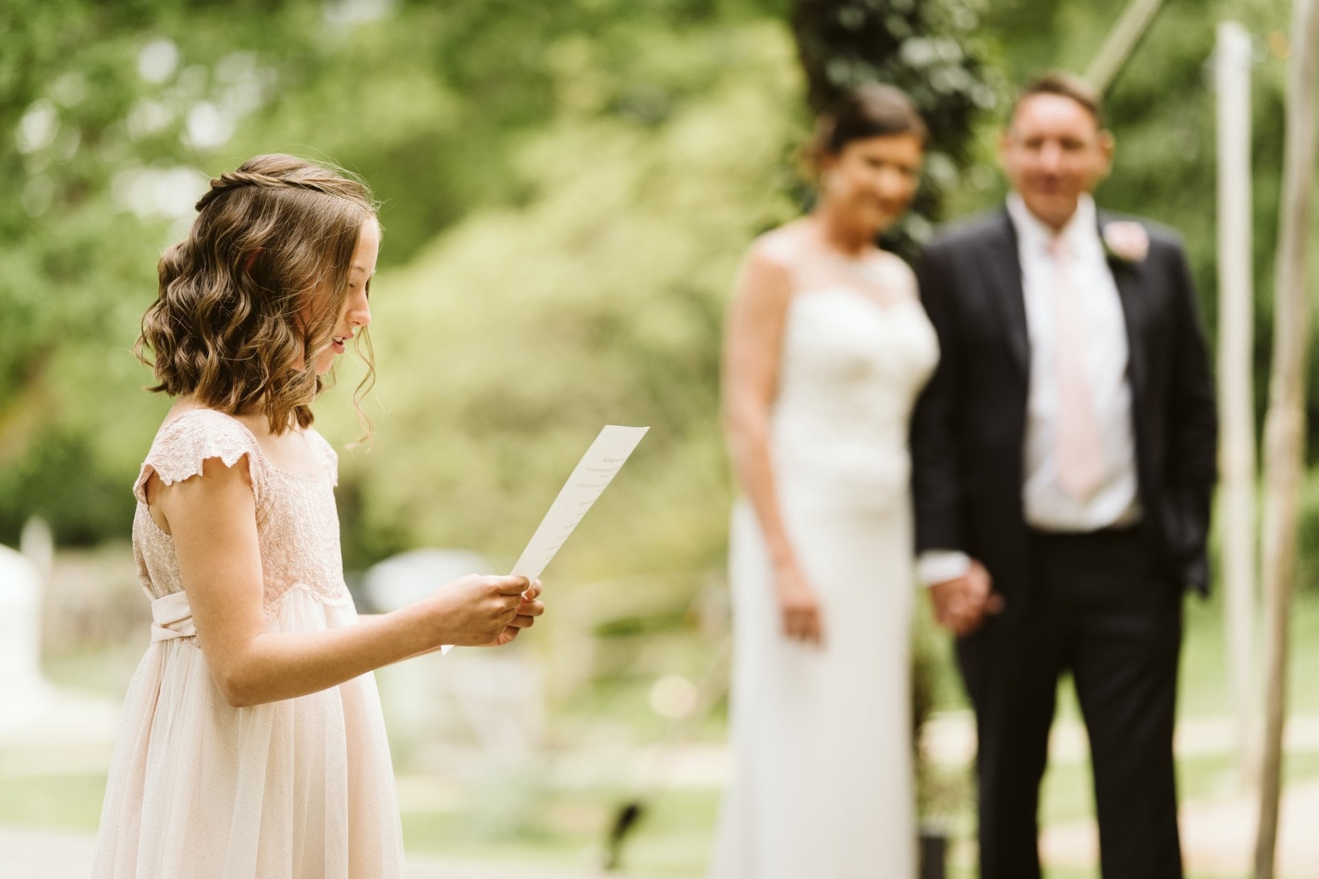 a young wedding guest performing a wedding reading