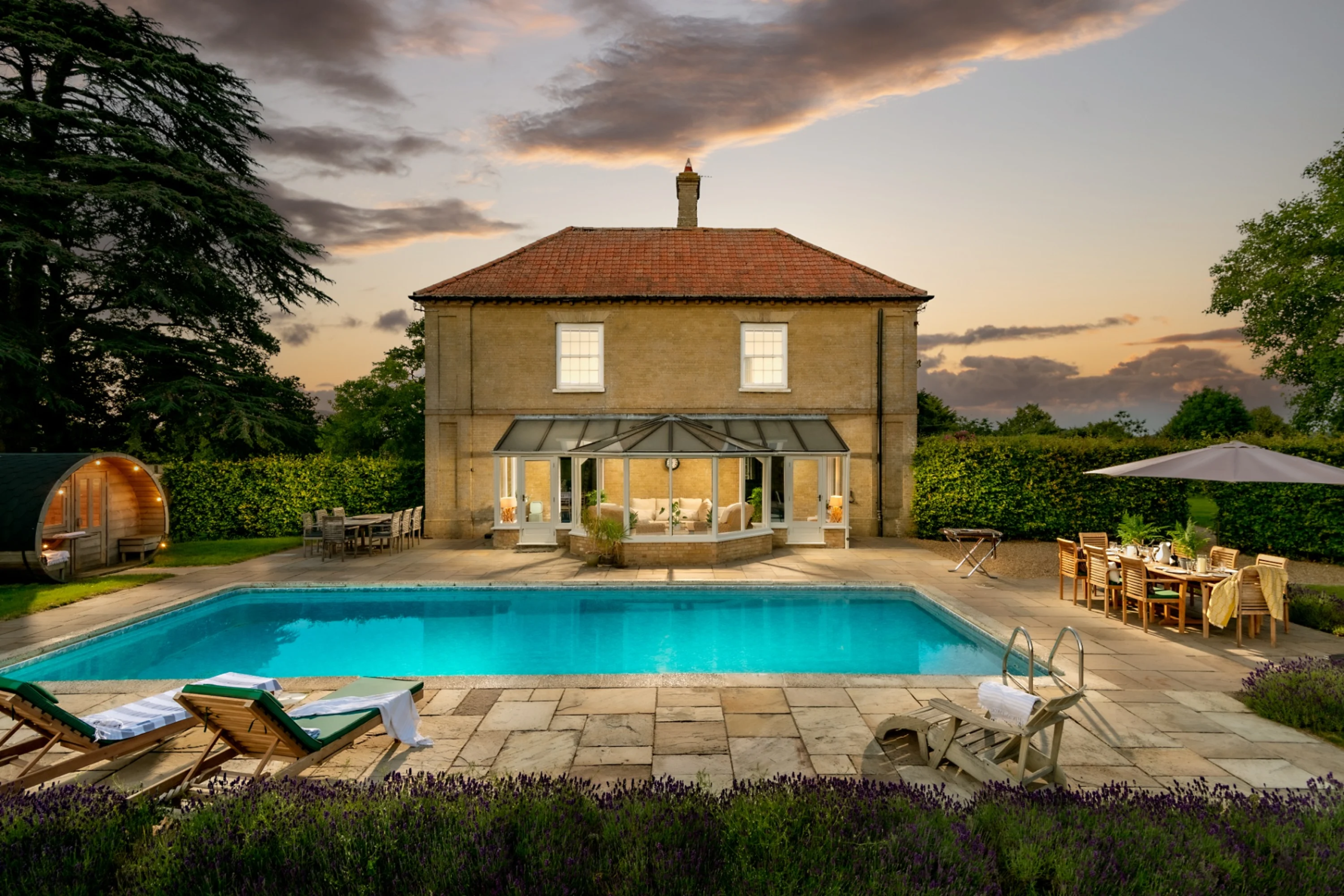 Godwick Great Barn, a 400-year-old wedding venue in Norfolk with heated outdoor pool and accommodation in shepherd's huts and bell tents