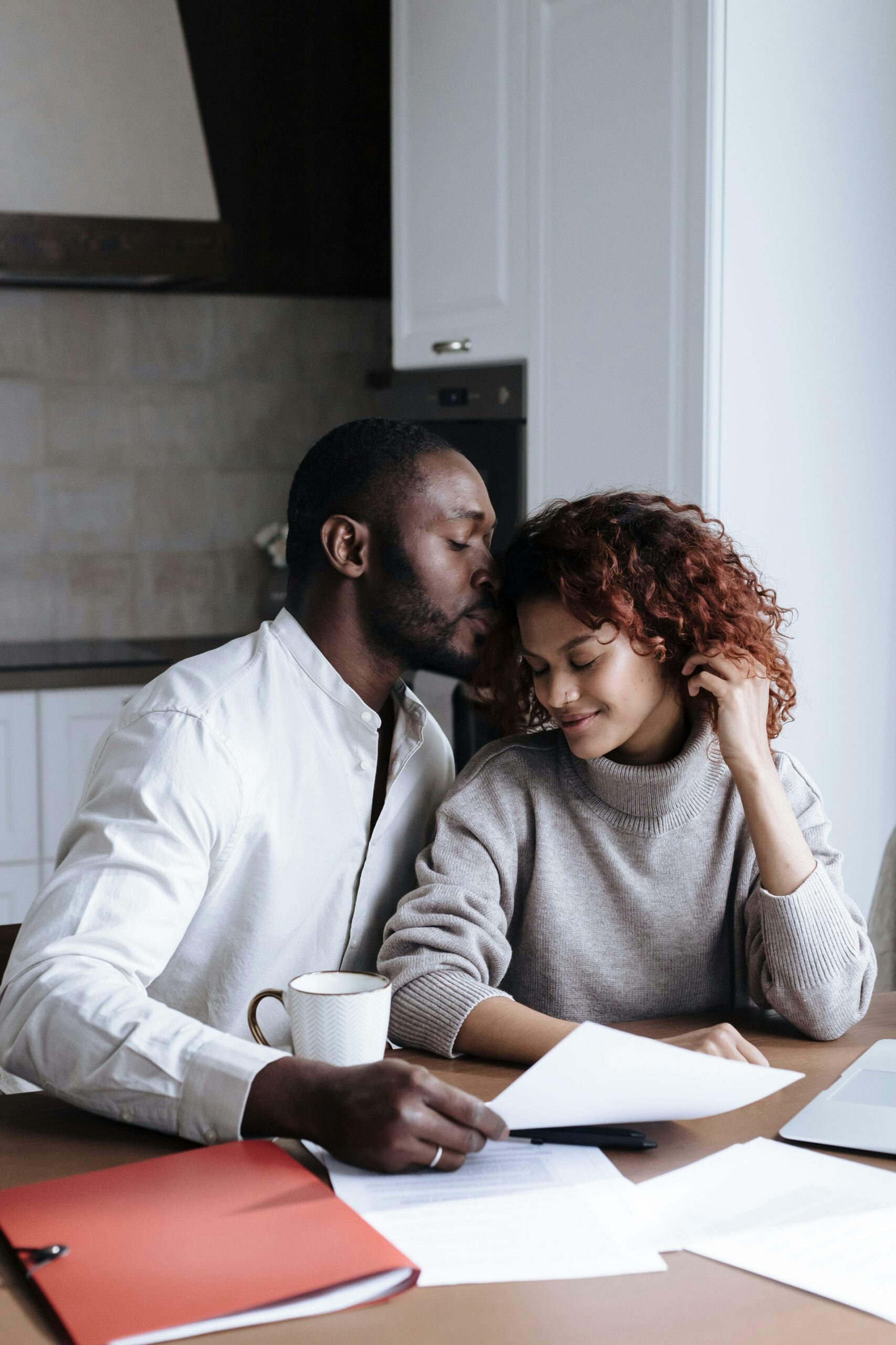 Bride and groom affectionately doing paperwork together