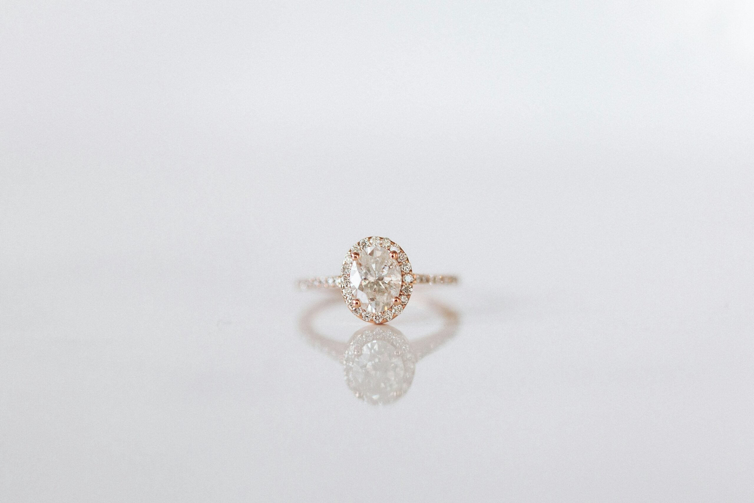 A diamond halo engagement ring on a diamond band