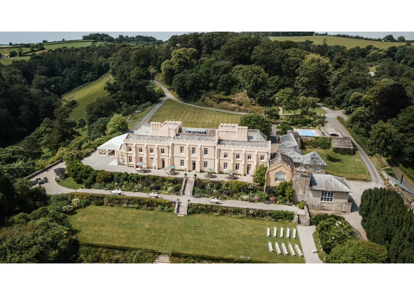 Marquee wedding celebrations at Pentillie Castle, a 1698 castle wedding venue in Cornwall with solar-heated outdoor pool