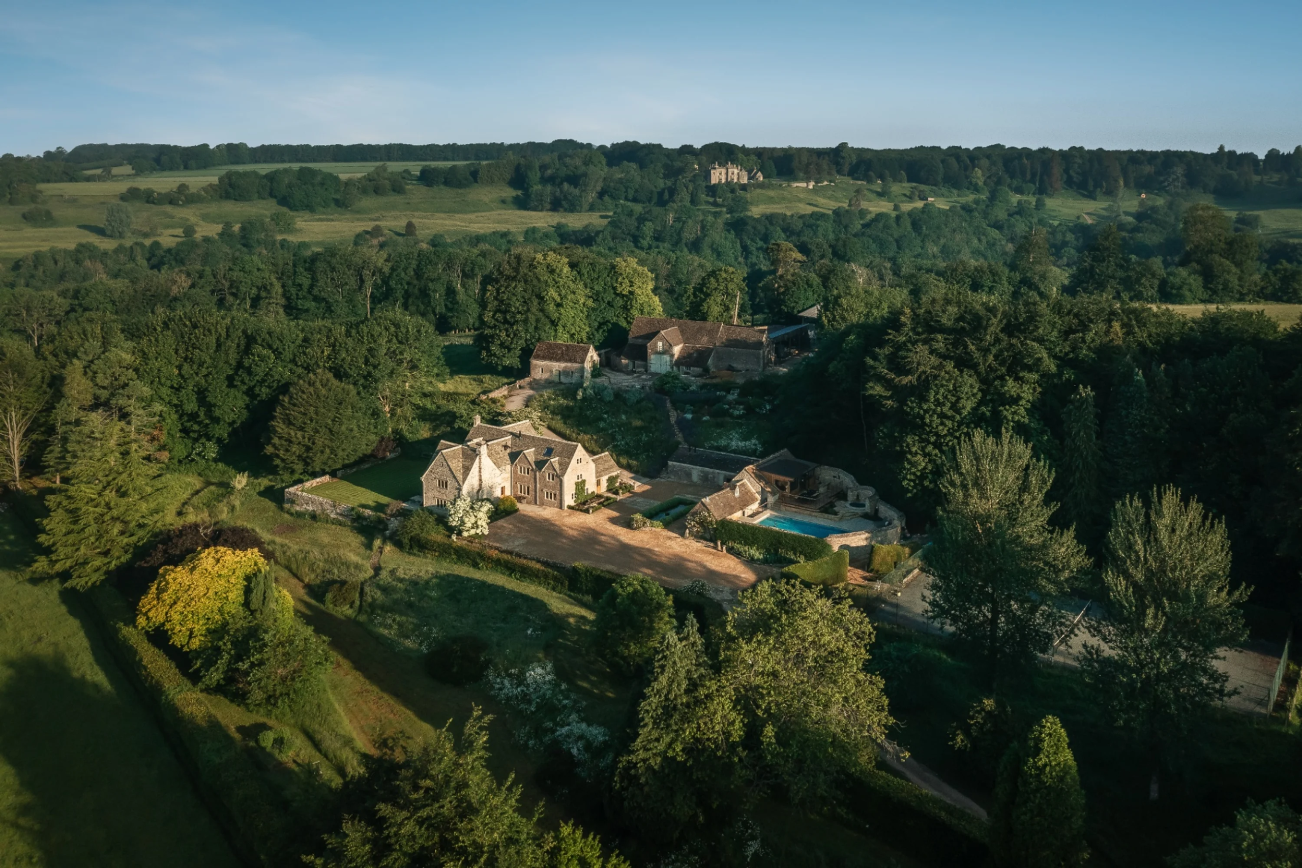 Stone wedding barn and wildflower meadows at Gulliver's Hall, a Cotswolds wedding venue with outdoor heated pool