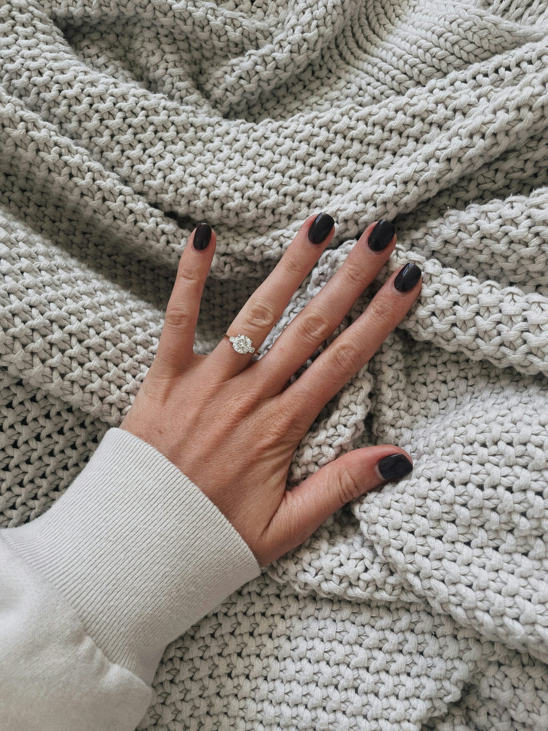 Hand spread out showing an engagement ring